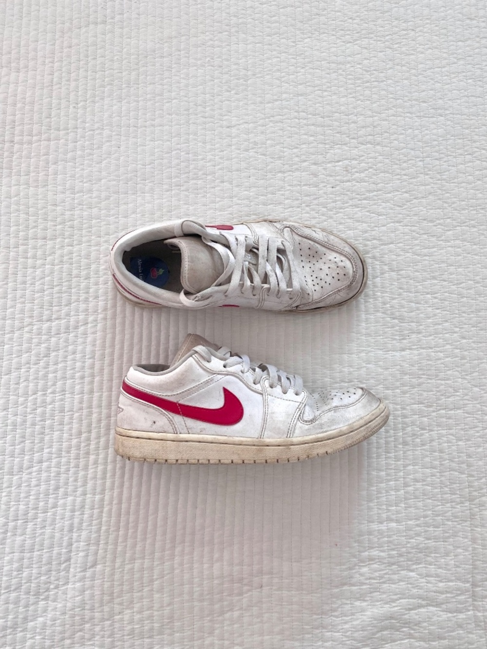 white and red Nike Air Force Jordan’s sneakers